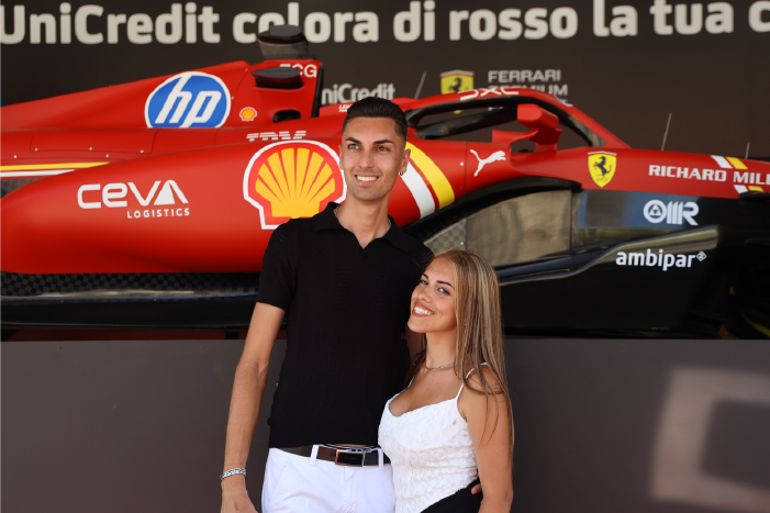A couple in front of a Ferrari F1 car