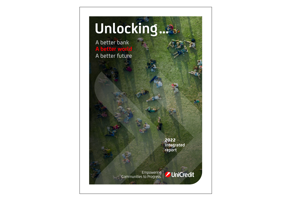 Cover of the UniCredit 2022 Integrated Report. The background is a photo of groups of people relaxing in the park, lying down or sitting on the grass. Superimposed the following text: Unlocking a better bank, a better world, a better future. 2022 Integrated Report